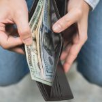 businessman-s-hands-opening-his-wallet-taking-out-money-finance-and-tax-concept-photo