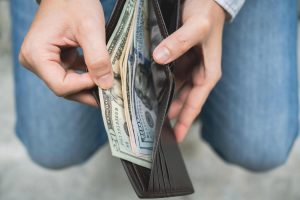 businessman-s-hands-opening-his-wallet-taking-out-money-finance-and-tax-concept-photo