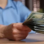 depositphotos_720794032-stock-photo-money-exchange-woman-holding-dollar