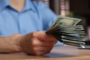 depositphotos_720794032-stock-photo-money-exchange-woman-holding-dollar